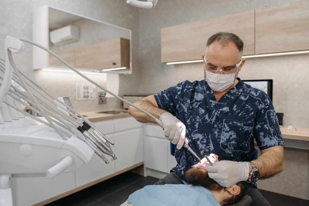 Dentiste utilisant un scanner intra-oral sans fil sur un patient, avec le modèle numérique 3D de la dentition affiché en temps réel sur un écran